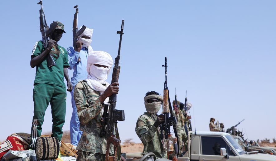 Fighters of armed defectors from the paramilitary Rapid Support Forces (RSF) raise their machine guns, as they are believed to be surrendering to the Sudanese army, in the west of Omdurman, just outside Khartoum, Sudan, Wednesday, Aug. 19, 2026. (AP Photo/Mohnd Blal)