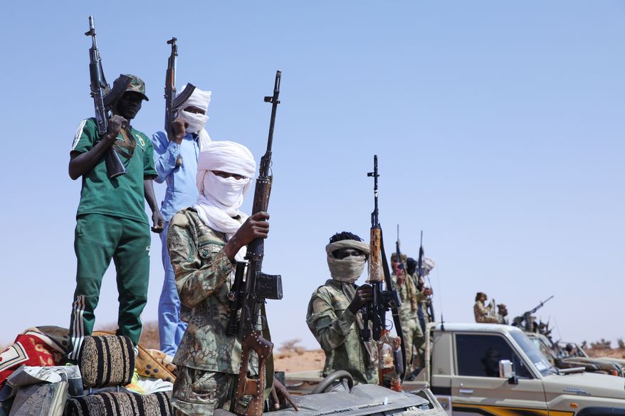Fighters of armed defectors from the paramilitary Rapid Support Forces (RSF) raise their machine guns, as they are believed to be surrendering to the Sudanese army, in the west of Omdurman, just outside Khartoum, Sudan, Wednesday, Aug. 19, 2026. (AP Photo/Mohnd Blal)
