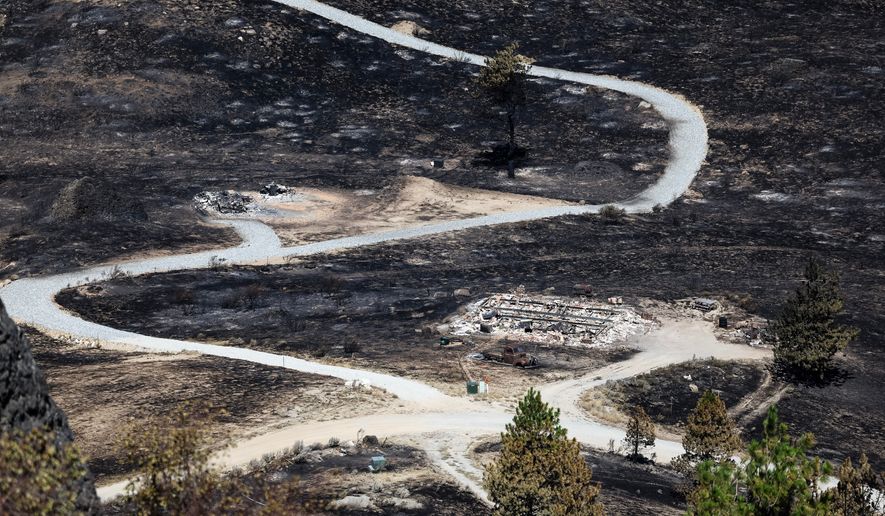Debris from a burnt house is scattered after the Chelan Hills Fire burned through McNeil Canyon on Wednesday, July 8, 2026, in Orondo, Wash. (Nick Wagner/The Seattle Times via AP)