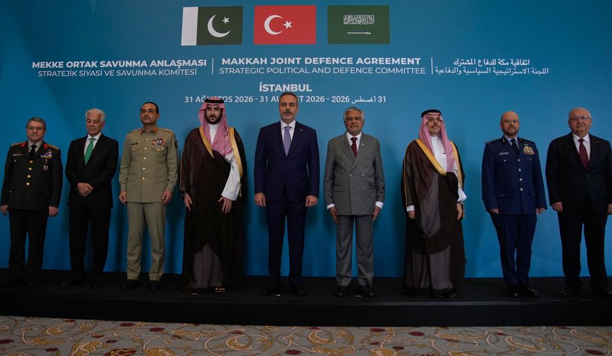 From center, Turkish Foreign Minister Hakan Fidan poses for a family photo with Pakistan's Foreign Minister Ishaq Dar, right, Saudi Foreign Minister Prince Faisal bin Farhan Al Saud, second right, and senior military and civilian officials from Turkey, Pakistan and Saudi Arabia at the first meeting of the Strategic Political and Defense Committee established under the Makkah Joint Defence Agreement in Istanbul, Turkey, Monday, Aug. 31, 2026. (AP Photo/Khalil Hamra)