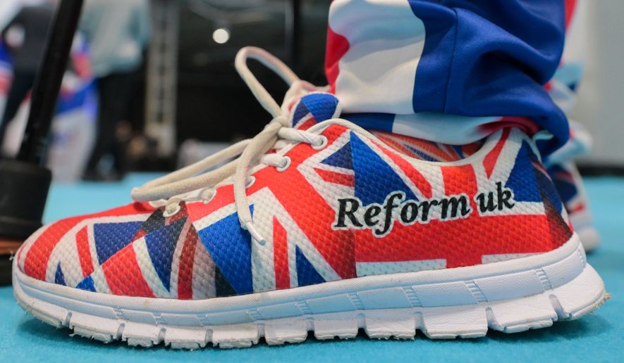 A member wears shoes in Union Flag colours during the Reform party's annual conference at the National Exhibition Centre in Birmingham, England, Friday, Sept. 4, 2026. (AP Photo/Thomas Krych)