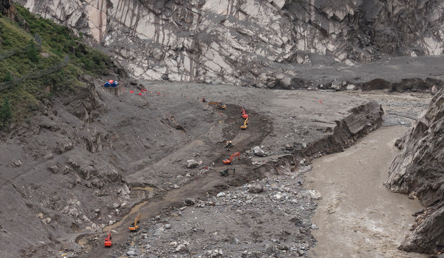 In this photo released by Xinhua News Agency, rescuers use excavators to clear a road at the core area of the mudslide-hit Gyirong Port in Gyirong County, southwestern China's Tibet Autonomous Region, Wednesday, Sept. 2, 2026. (Tenzing Nima Qadhup/Xinhua via AP)