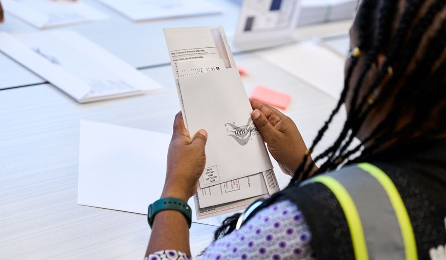Wake County Board of Elections employees prepare absentee ballots to be mailed on Thursday, Sept. 3, 2026, in Raleigh, N.C. (AP Photo/Matt Ramey)