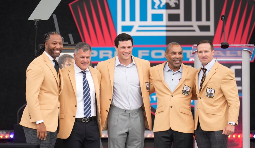 From left, former NLF players Larry Fitzgerald, Adam Vinatieri, Luke Kuechley, Roger Craig, and Drew Brees pose for a photo during the Pro Football Hall of Fame induction ceremony at the Pro Football Hall of Fame, in Canton, Ohio, Saturday, Aug. 8, 2026. (AP Photo/Sue Ogrocki)