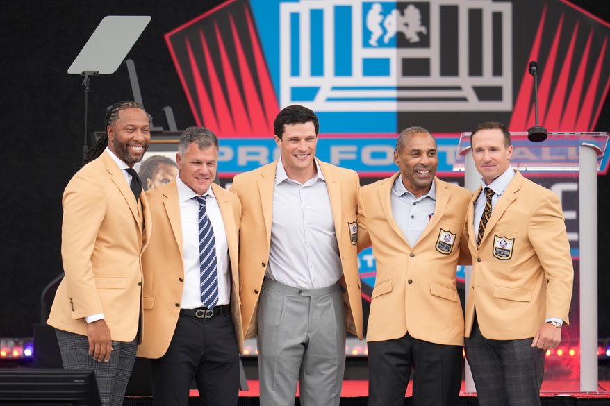 From left, former NLF players Larry Fitzgerald, Adam Vinatieri, Luke Kuechley, Roger Craig, and Drew Brees pose for a photo during the Pro Football Hall of Fame induction ceremony at the Pro Football Hall of Fame, in Canton, Ohio, Saturday, Aug. 8, 2026. (AP Photo/Sue Ogrocki)