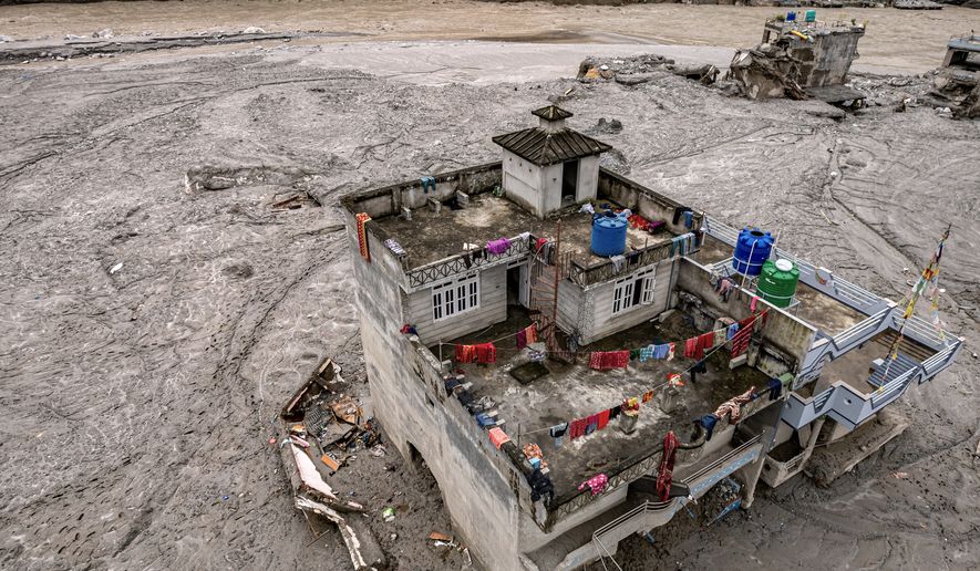 A drone view shows a damaged residential building along the swollen Trishuli River in the aftermath of flash floods in Nepal's Nuwakot district, Thursday, Sept. 3, 2026. (AP Photo/Rajesh Kumar Singh)