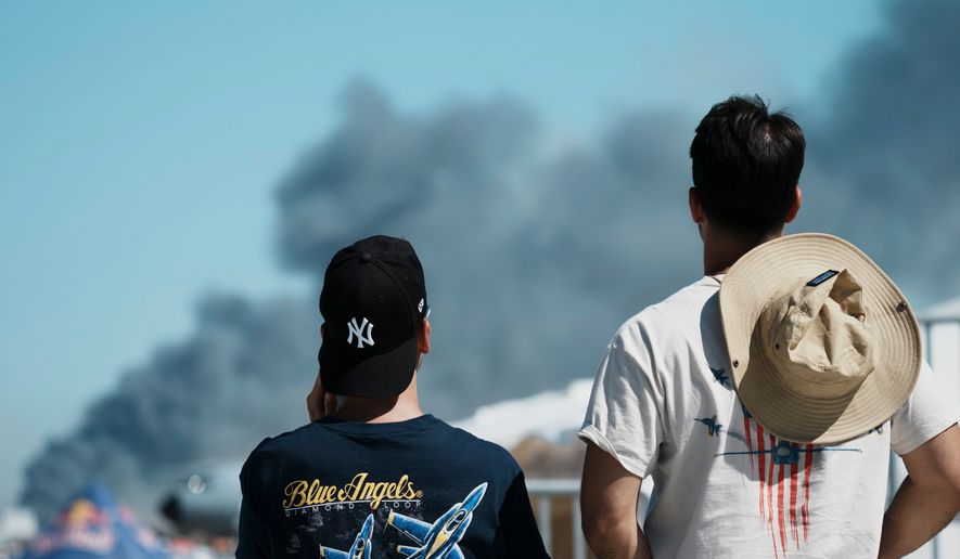 Spectators watch as smoke rises after a Hellenic Air Force F-4 Phantom fighter jet crashed, during the Athens Flying Week airshow at Tanagra Air Force Base, north of Athens, Greece, Saturday, Sept. 5, 2026. (AP Photo/Kallista Allaway)
