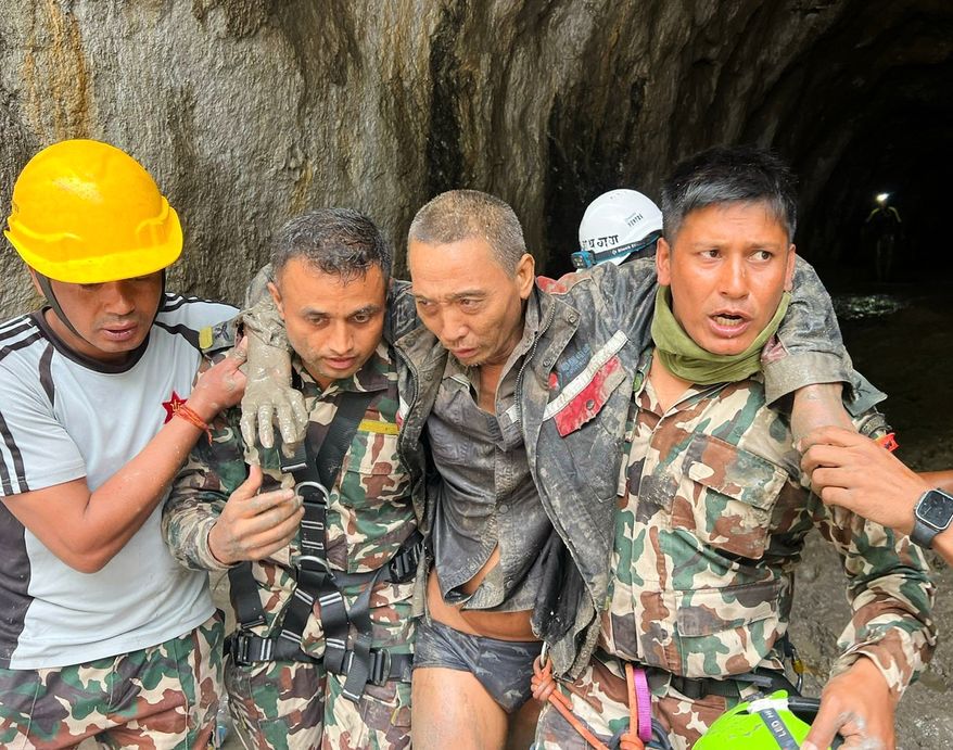 In this photo provided by the Nepal Army, a Chinese national is seen after being rescued by soldiers during an ongoing operation at the Trishuli-3A hydropower project in Nepal's Rasuwa district, Saturday, Sept. 5, 2026. (Nepal Army via AP)