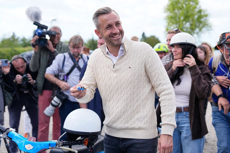 Ulrich Siegmund, top candidate for the "Alternative for Germany" (AfD) party how's his motorcycle keys in party coolers after voting at a polling station during the Saxony-Anhalt state elections in Tangermuende, eastern Germany, Sunday, Sept. 6, 2026. (AP Photo/Matthias Schrader)