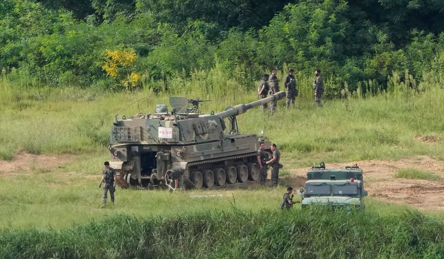 South Korean army soldiers work near their K-9 self-propelled howitzer in Paju, South Korea, near the border with North Korea, Sunday, Sept. 6, 2026. (AP Photo/Ahn Young-joon)