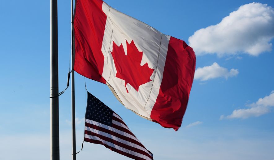 The national flags of Canada, front, and the United States fly outside the Galleria Mall in Buffalo, New York, Wednesday, Aug. 26, 2026. (AP Photo/Gene J. Puskar)
