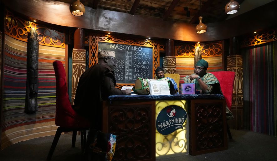 A contestant competes on a game show called Masoyinbo, which translates to "Do not speak English," in Lagos, Nigeria, Monday, July 27, 2026. (AP Photo/Sunday Alamba)
