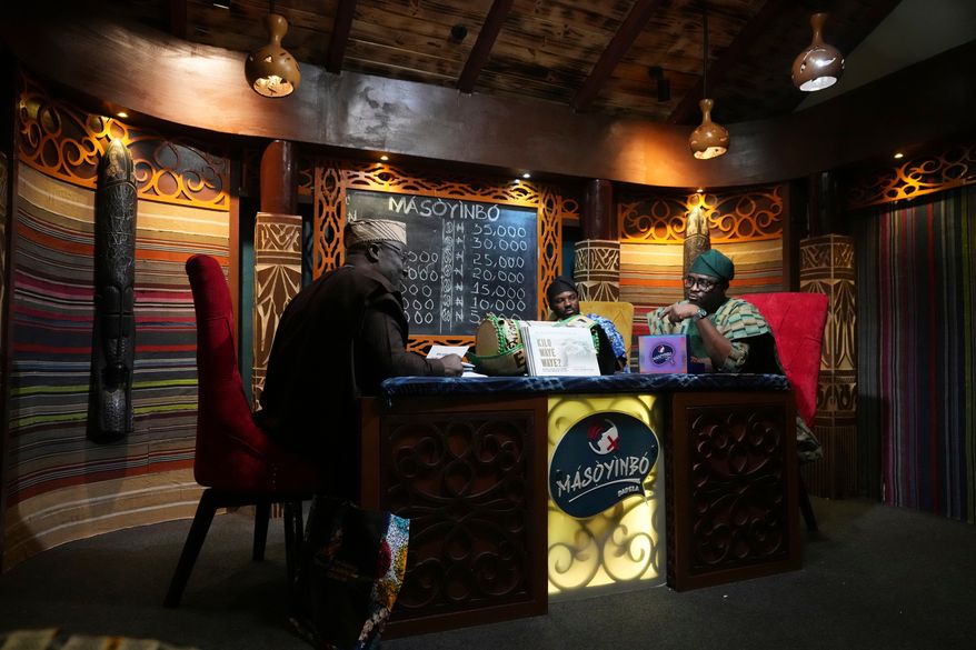 A contestant competes on a game show called Masoyinbo, which translates to "Do not speak English," in Lagos, Nigeria, Monday, July 27, 2026. (AP Photo/Sunday Alamba)