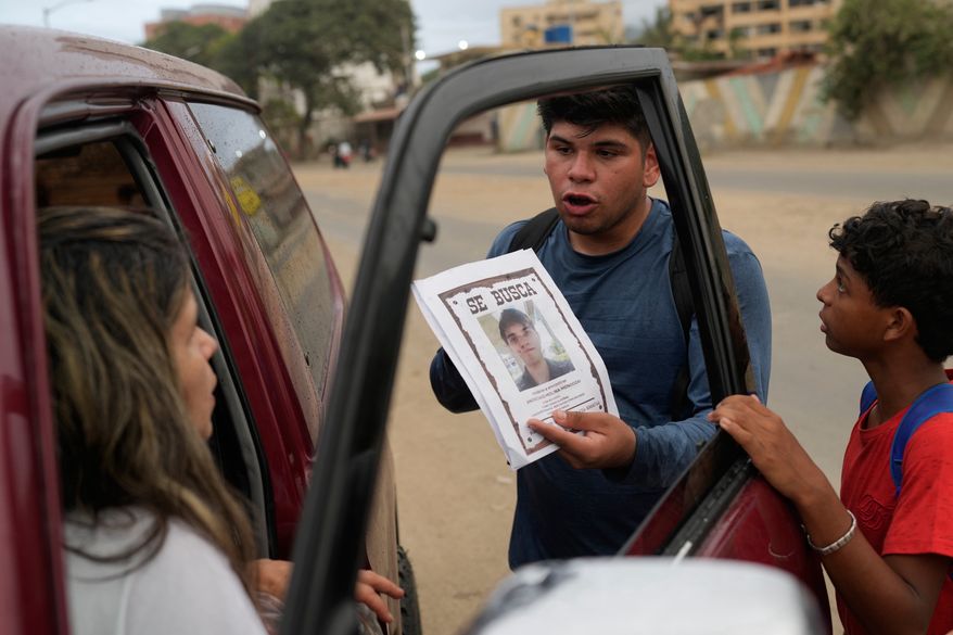 Pedro Gomez asks people about his cousin, Andres Molina, who has been missing since the earthquakes, in La Guaira, Venezuela, Saturday, Aug. 22, 2026. (AP Photo/Ariana Cubillos)