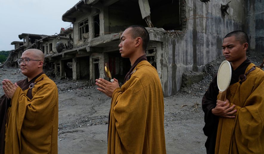 Buddhist monks offer prayers for the departed soul of the victims of flash flood on the bank of Trishuli river in Devighat, Nuwakot district, Nepal, Saturday, Sept. 5, 2026. (AP Photo/Niranjan Shrestha)