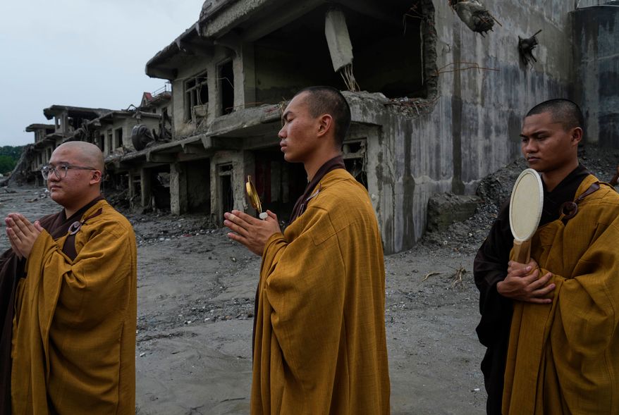 Buddhist monks offer prayers for the departed soul of the victims of flash flood on the bank of Trishuli river in Devighat, Nuwakot district, Nepal, Saturday, Sept. 5, 2026. (AP Photo/Niranjan Shrestha)
