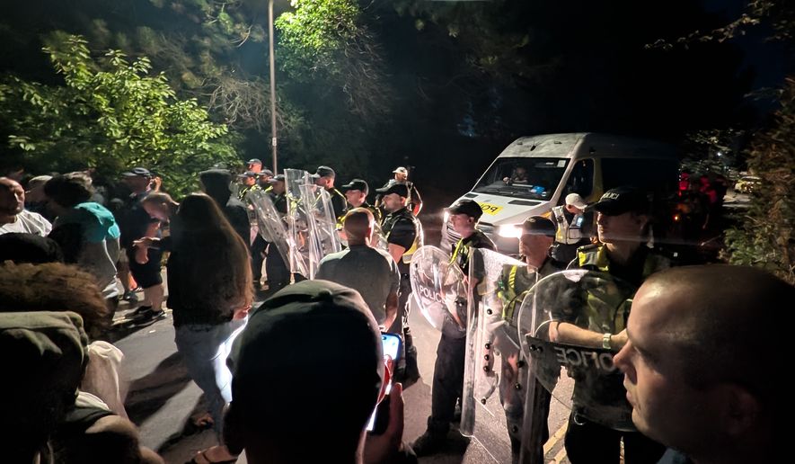 Police officers form a line to block protesters near Eastney Beach, in Portsmouth, England, Sunday, Sept. 6, 2026. (PA via AP)