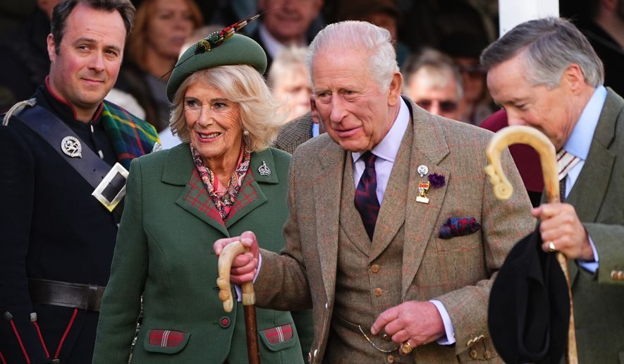 Britain's King Charles III and Queen Camilla walk, during the Braemar Gathering highland games at the Princess Royal and Duke of Fife Memorial Park, in Aberdeenshire, Scotland, Saturday, Sept. 5, 2026. (Aaron Chown/PA via AP)