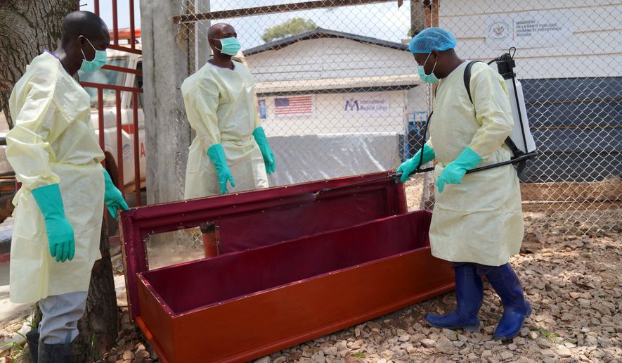 Health workers who are members of the safe and dignified burial team disinfect a coffin to bury Abineno Justine, a 38 year old woman who died of the Ebola virus, in Bunia, Congo, Friday, Sept. 4, 2026. (AP Photo/Dieudonne Dirole)