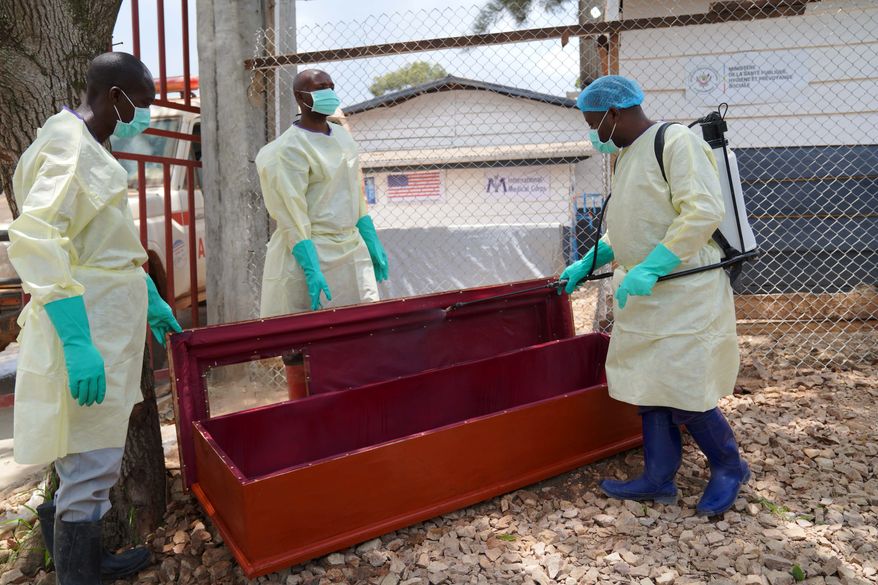 Health workers who are members of the safe and dignified burial team disinfect a coffin to bury Abineno Justine, a 38 year old woman who died of the Ebola virus, in Bunia, Congo, Friday, Sept. 4, 2026. (AP Photo/Dieudonne Dirole)