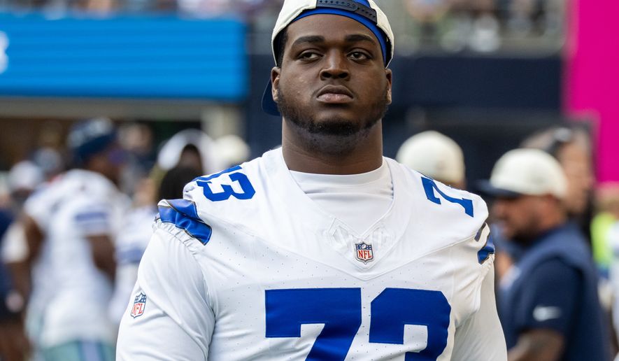 FILE - Dallas Cowboys offensive lineman Tyler Smith stands on the sideline during an NFL preseason football game against the Seattle Seahawks, Aug. 15, 2026, in Seattle. (AP Photo/Stephen Brashear, File)