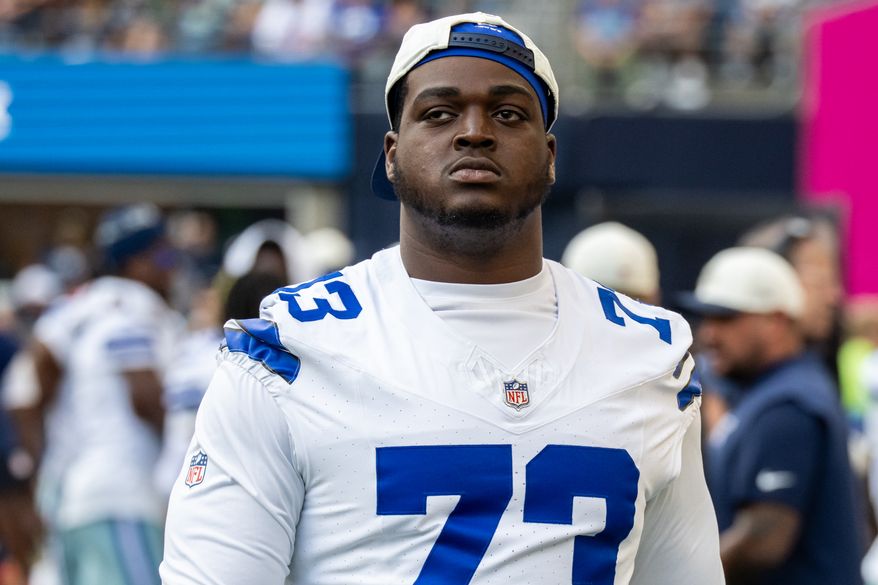 FILE - Dallas Cowboys offensive lineman Tyler Smith stands on the sideline during an NFL preseason football game against the Seattle Seahawks, Aug. 15, 2026, in Seattle. (AP Photo/Stephen Brashear, File)