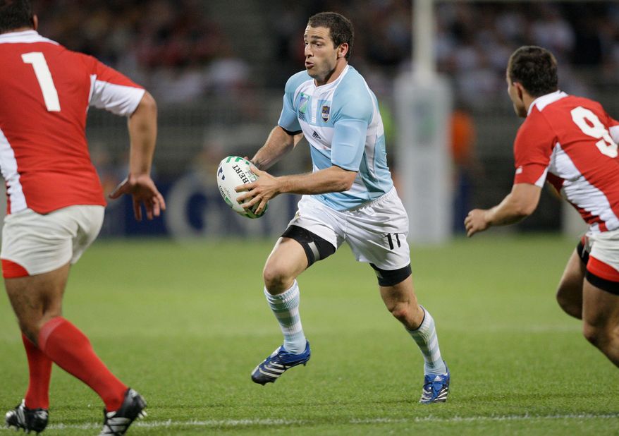 File - Argentina's Federico Martin Aramburu, center, runs with the ball during their Rugby World Cup Group D match between Argentina and Georgia, in Lyon, France, on Sept.11, 2007. (AP Photo/Mark Baker, File)