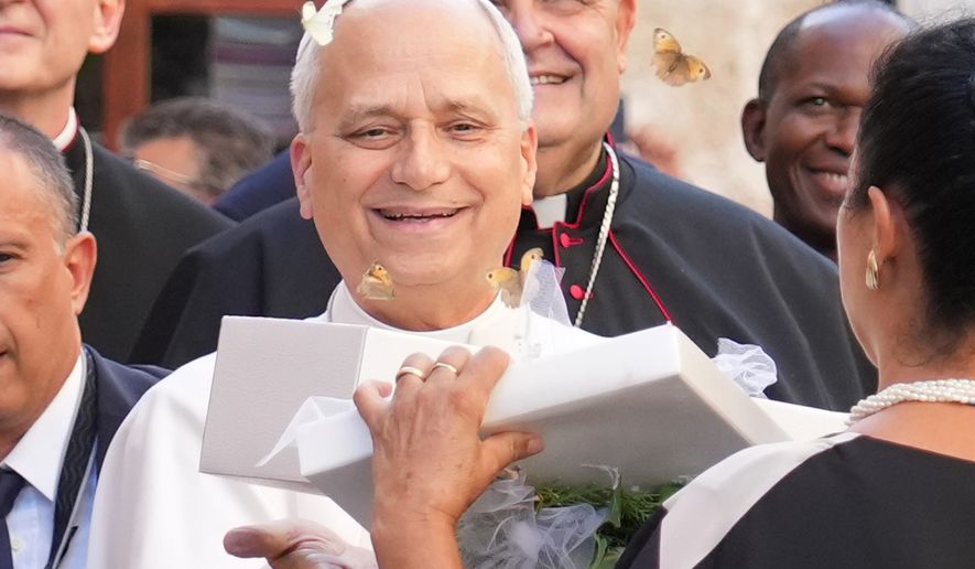 Pope Leo XIV receives a box with butterflies as he arrives at the Basilica Sanctuary of the Mother of Good Counsel in Genazzano, central Italy, Monday, Sept. 7, 2026. (AP Photo/Andrew Medichini)