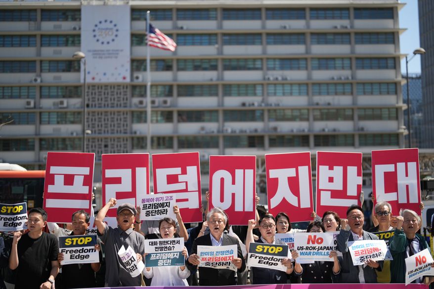 Protesters shout slogans demanding to stop the South Korea, U.S. and Japan trilateral military drill called "Freedom Edge" near the U.S. Embassy in Seoul, South Korea, Monday, Sept. 7, 2026. The letters read "Oppose the Freedom Edge." (AP Photo/Lee Jin-man)