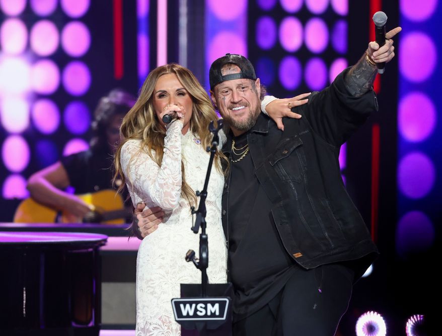 Jelly Roll makes a surprise appearance with Carly Pearce as she performs Dolly Parton's, 9 to 5, during a show dedicated to the late Dolly Parton at the Grand Ole Opry, Saturday, Aug. 29, 2026, in Nashville, Tenn. (AP Photo/Adin Parks)