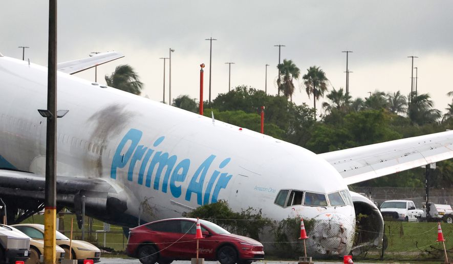 An Amazon cargo plane sits at Miami International Airport after overshooting a runway on Monday, Sept. 7, 2026, in Miami. (AP Photo/David Santiago)