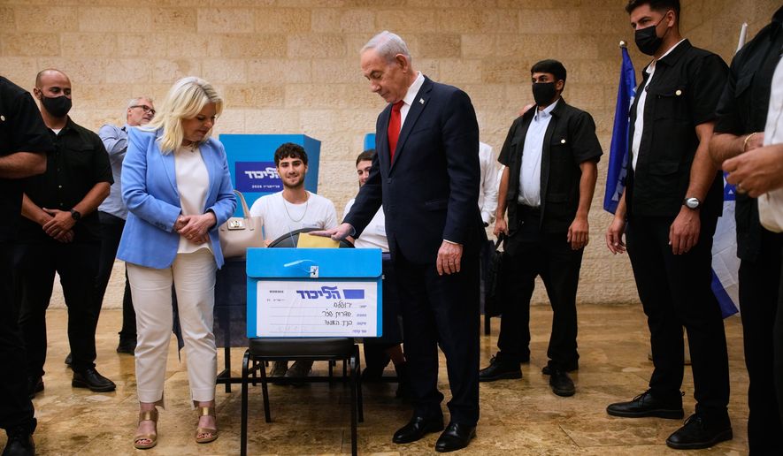 Israeli Prime Minister Benjamin Netanyahu, right, and his wife, Sara, cast their ballots in the Likud party primary elections ahead of Israel's general election in October, in Jerusalem, Monday, Aug. 17, 2026. (AP Photo/Ohad Zwigenberg, Pool)