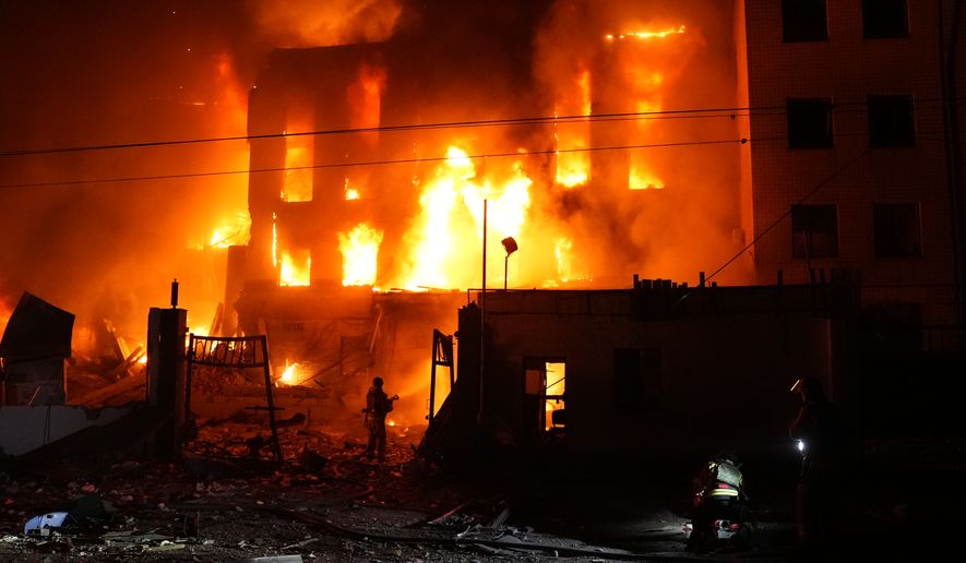 A rescue worker puts out a fire of a building destroyed after a Russian missile attack in Kyiv, Ukraine Tuesday, Sept. 8, 2026. (AP Photo/Alex Babenko)