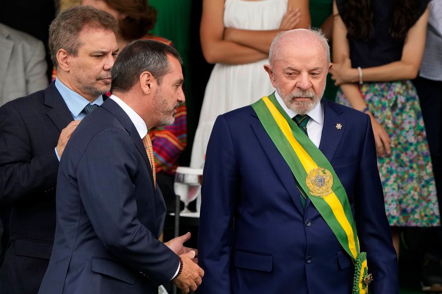 Brazilian President Luiz Inacio Lula da Silva, right, speaks with Federal Police Director General Andrei Rodrigues, center, next to Justice Minister Wellington Cesar, far left, during Independence Day celebrations in Brasilia, Brazil, Monday, Sept. 7, 2026. (AP Photo/Eraldo Peres)