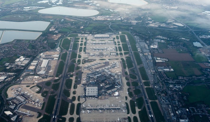 FILE- Heathrow Airport is seen from an airplane, Oct. 6, 2025, in London. (AP Photo/Julia Demaree Nikhinson, File)