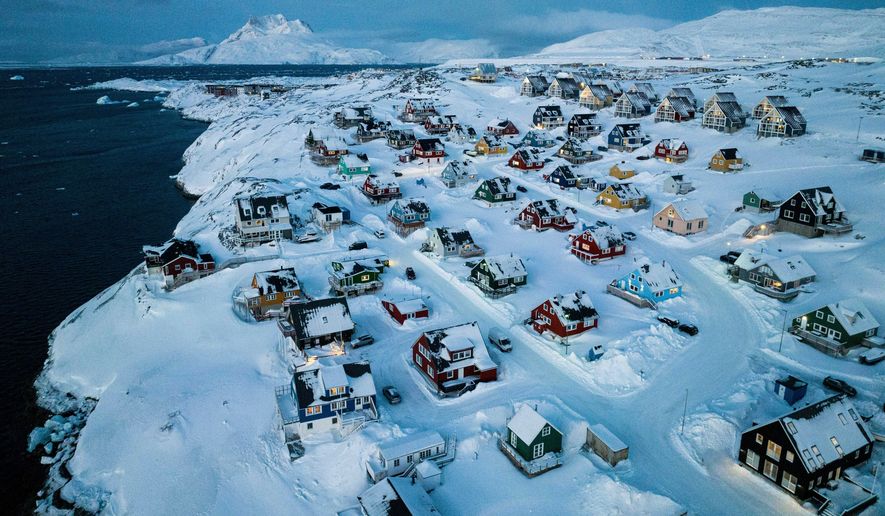 Houses covered in snow are seen on the coast of a sea inlet of Nuuk, Greenland, on March 7, 2025. (AP Photo/Evgeniy Maloletka) **FILE**