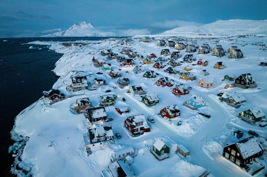 Houses covered in snow are seen on the coast of a sea inlet of Nuuk, Greenland, on March 7, 2025. (AP Photo/Evgeniy Maloletka) **FILE**