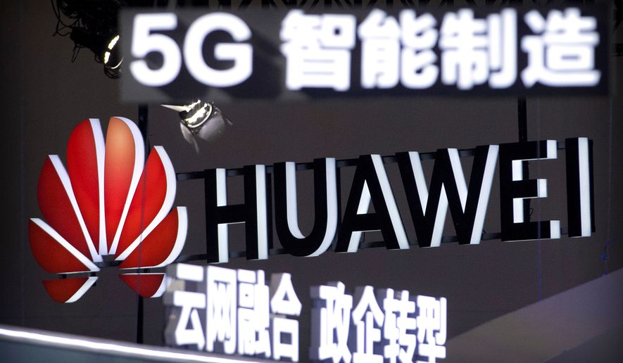 FILE - Signs promoting 5G wireless technology from Chinese technology firm Huawei are displayed at the PT Expo in Beijing on Sept. 26, 2018. (AP Photo/Mark Schiefelbein, File)