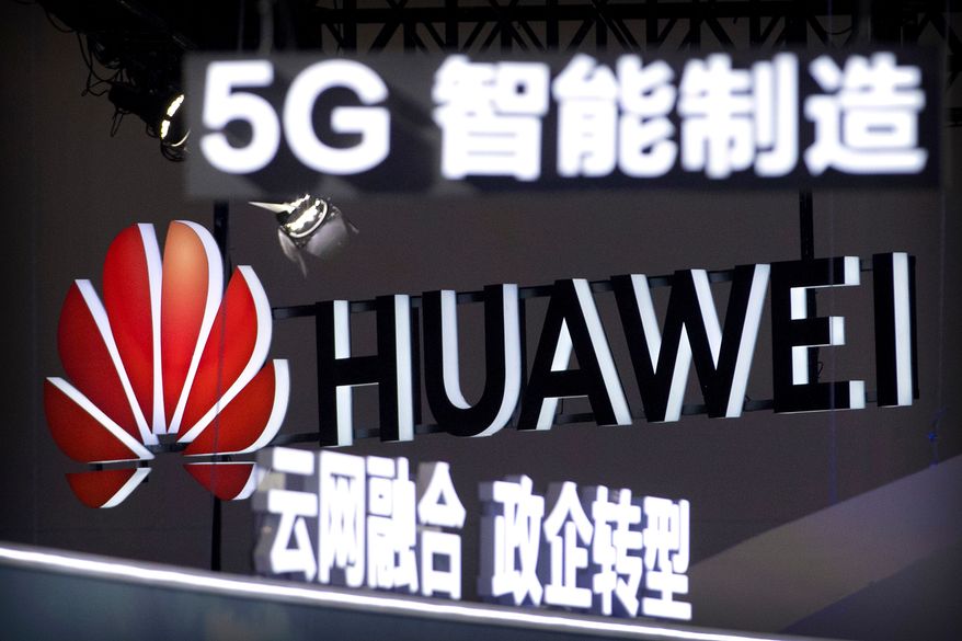 FILE - Signs promoting 5G wireless technology from Chinese technology firm Huawei are displayed at the PT Expo in Beijing on Sept. 26, 2018. (AP Photo/Mark Schiefelbein, File)