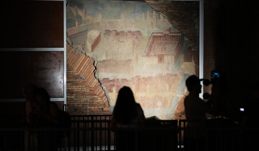 Reporters film the "The Painted City" fresco, discovered during 1990s built as foundations for the Baths of Trajan that has been restored, in Rome, Tuesday, Sept. 8, 2026.(AP Photo/Andrew Medichini)