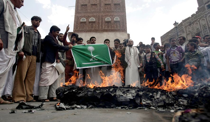FILE - Members of the Yemeni al-Houthi Shiite rebel group burn an effigy of a U.S. aircraft and a Saudi flag during a demonstration against U.S. and Saudi interference in Yemen, after Friday prayer in Sanaa, Yemen, on April 12, 2013. (AP Photo/Hani Mohammed), File
