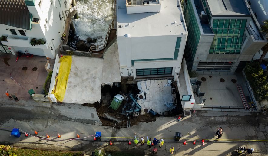 An aerial view of a sinkhole which collapsed the driveway of a coastal mansion owned by actor Nicolas Cage Tuesday, Sept. 8, 2026, in Malibu, Calif. (AP Photo/Ethan Swope)
