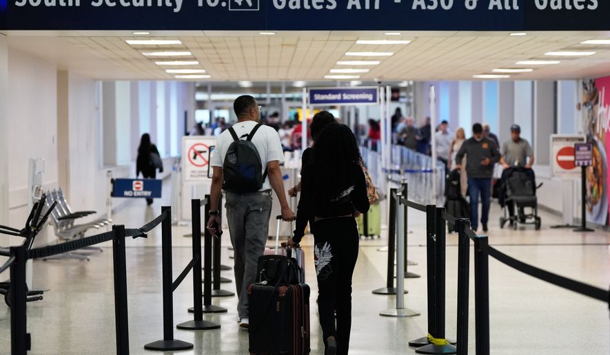 FILE - Travelers walk through TSA security lines at George Bush Intercontinental Airport on March 30, 2026, in Houston. (AP Photo/Ashley Landis, File)