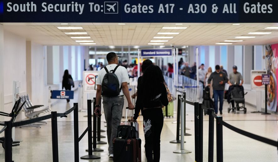 Travelers walk through TSA security lines at George Bush Intercontinental Airport in Houston on March 30, 2026. (AP Photo/Ashley Landis) **FILE**