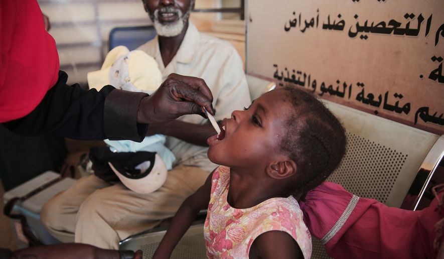FILE - A Sudanese girl receives an oral cholera vaccine during a vaccination campaign conducted by health ministry workers in Khartoum, Sudan, Aug. 13, 2025. (AP Photo/Marwan Ali, File)