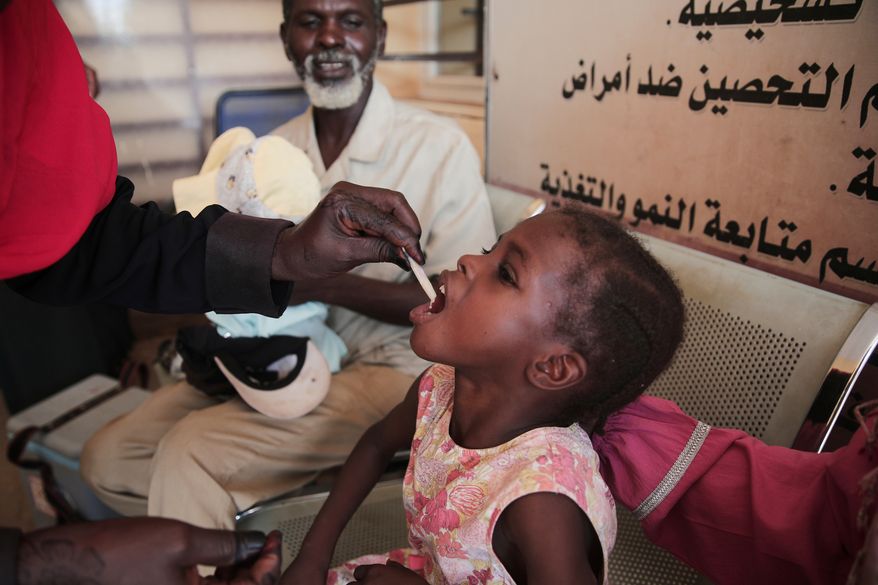 FILE - A Sudanese girl receives an oral cholera vaccine during a vaccination campaign conducted by health ministry workers in Khartoum, Sudan, Aug. 13, 2025. (AP Photo/Marwan Ali, File)