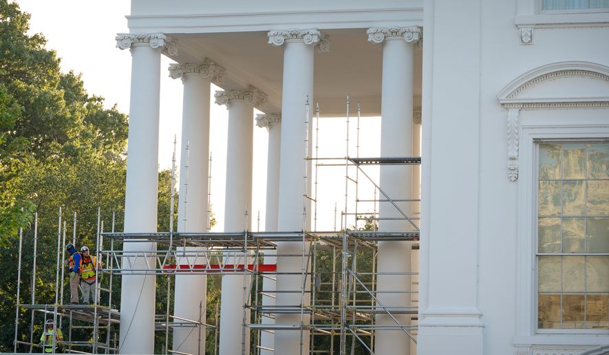 Workers remove scaffolding from columns at the North Portico of the White House, Tuesday, Sept. 8, 2026, in Washington. (AP Photo/Mark Schiefelbein)