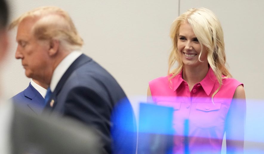 White House aide Natalie Harp, right, looks after President Donald Trump, left, spoke to astronauts aboard the International Space Station, Friday, Aug. 28, 2026, at Johnson Space Center's Mission Control in Houston. (AP Photo/Mark Schiefelbein)