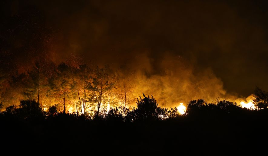 In this handout photo released by Antalya Metropolitan Municipality, flames from a wildfire burn through a forest near Antalya, Turkey, Monday, Sept. 7, 2026. (Antalya Metropolitan Municipality via AP)