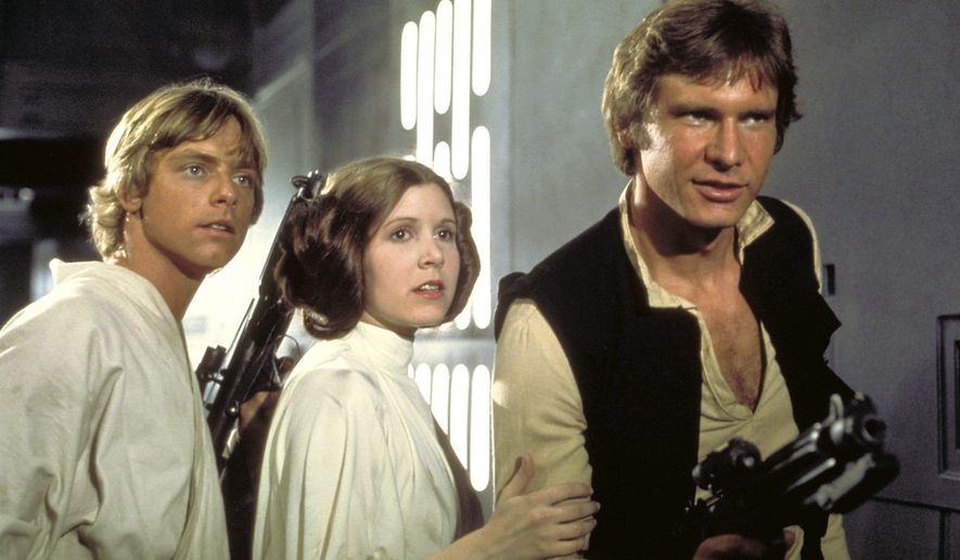 From left: Luke Skywalker (Mark Hamill), Princess Leia (Carrie Fisher) and Han Solo (Harrison Ford) attempt to escape the clutches of Darth Vader aboard the Death Star in a scene from "Star Wars: Episode IV — A New Hope." (Lucasfilm Ltd.) **FILE**